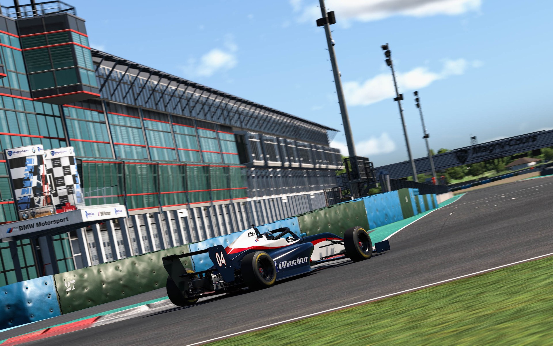 An FIA F4 car on iRacing racing past the grandstand at Magny-Cours
