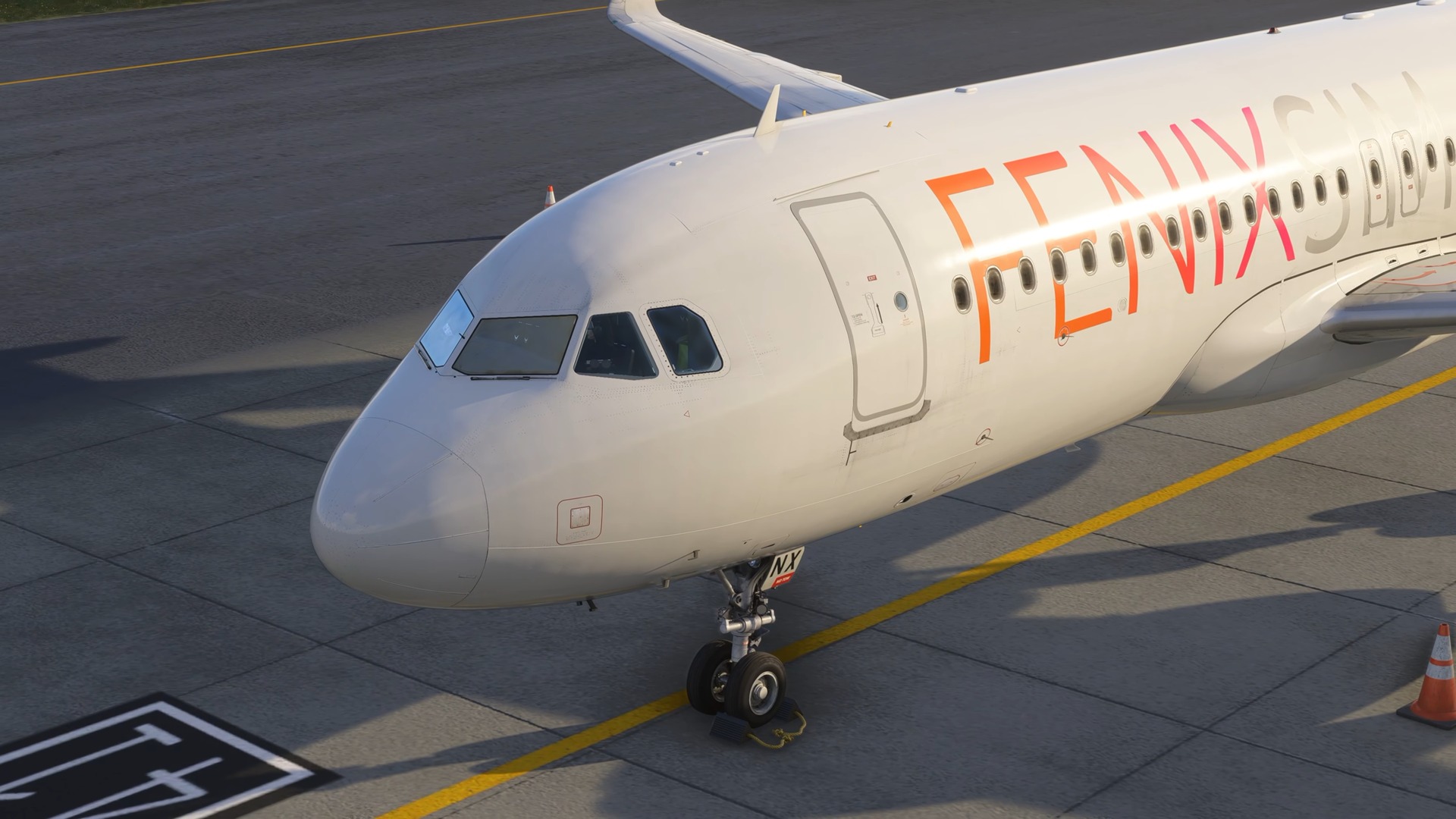 The Fenix A320 in Fenix house livery parked on the apron, seen from the nose.