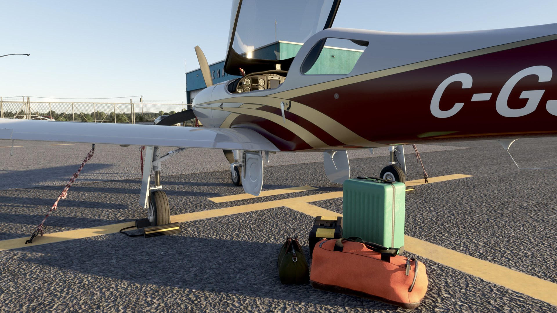 A parked Legacy RG550 seen from the side, with luggage on the apron beside it