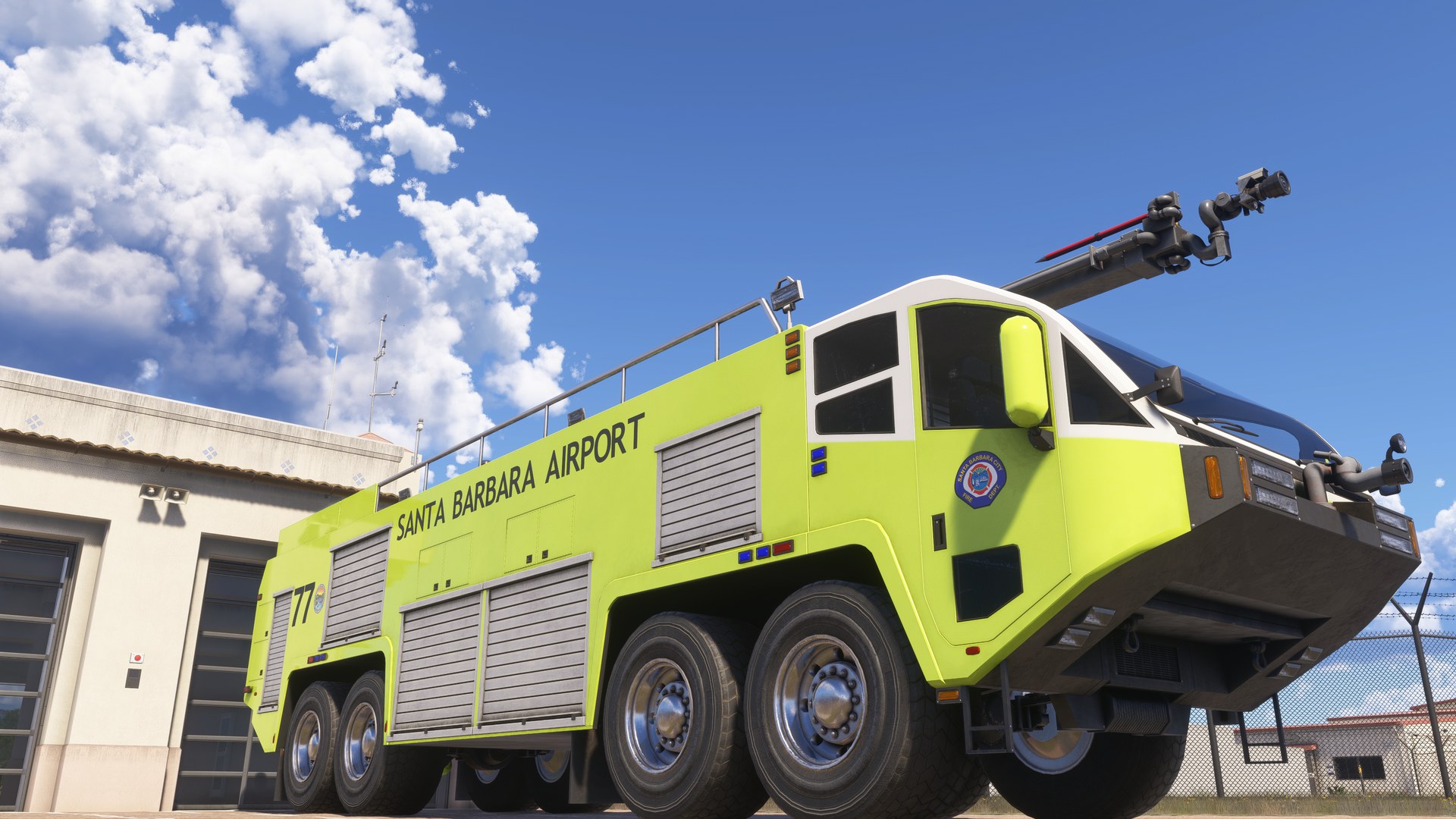 A yellow-green airport fire truck marked "Santa Barbara Airport" parked outside the fire station